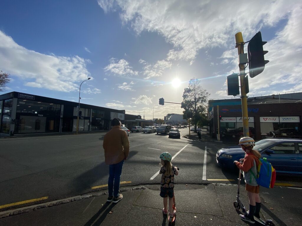 Children en route to school on scooters, along Great North Road (unimproved).